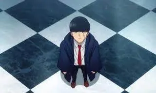 a man in a suit and tie sitting on a checkered floor