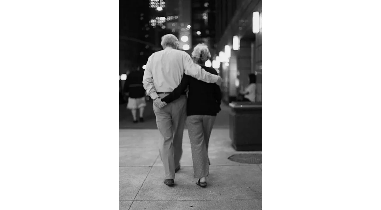 a man and a woman walking down a sidewalk