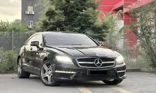 a black car parked on the side of a road