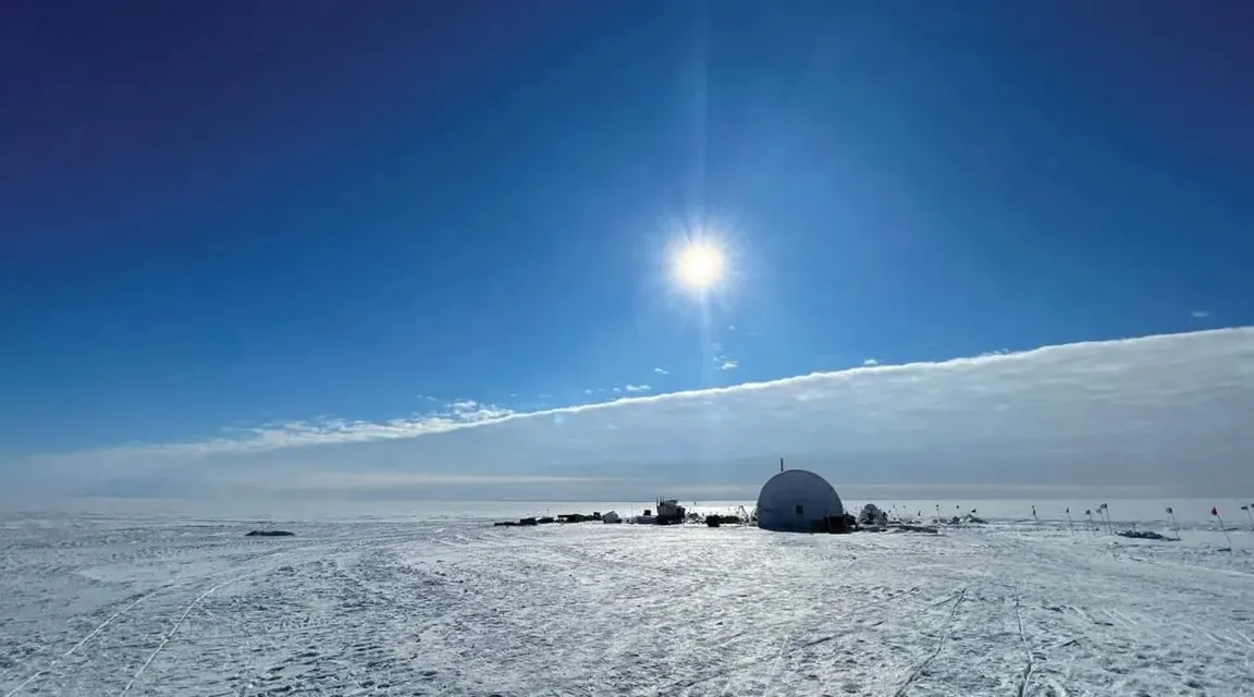 the sun shines brightly over a snowy landscape