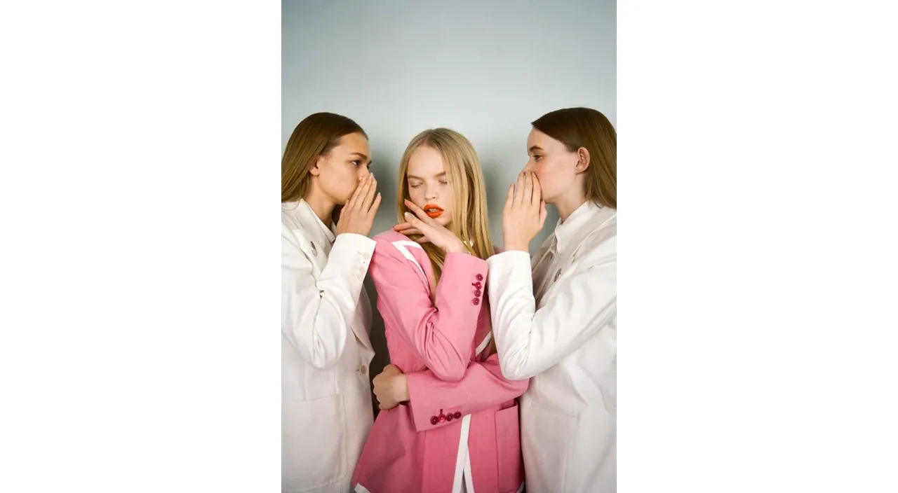 three women in white lab coats standing next to each other