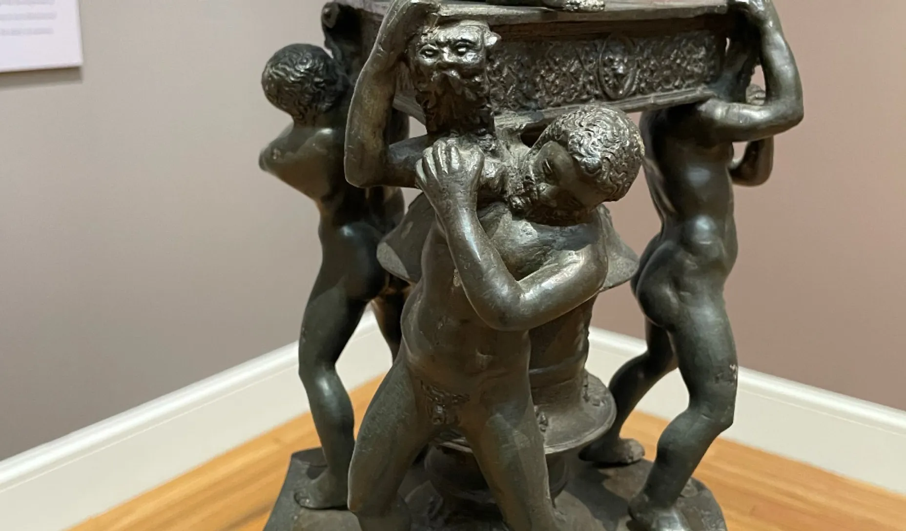 three demon bronze statues wave their left hand down, camera moves in, advertising style