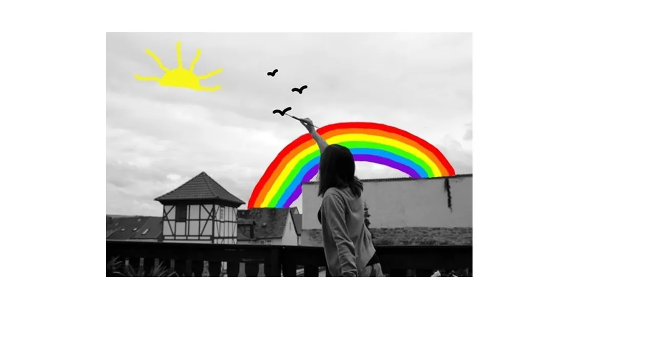 a woman standing in front of a rainbow