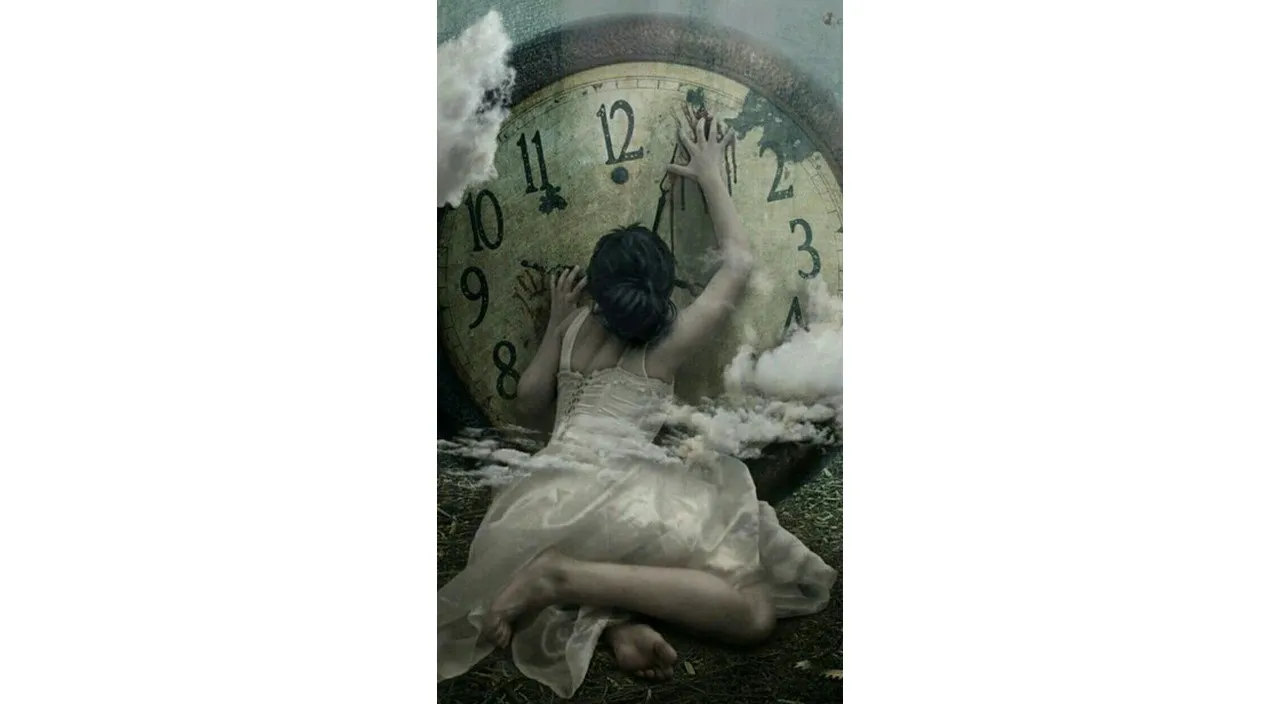 a woman laying on the ground in front of a clock