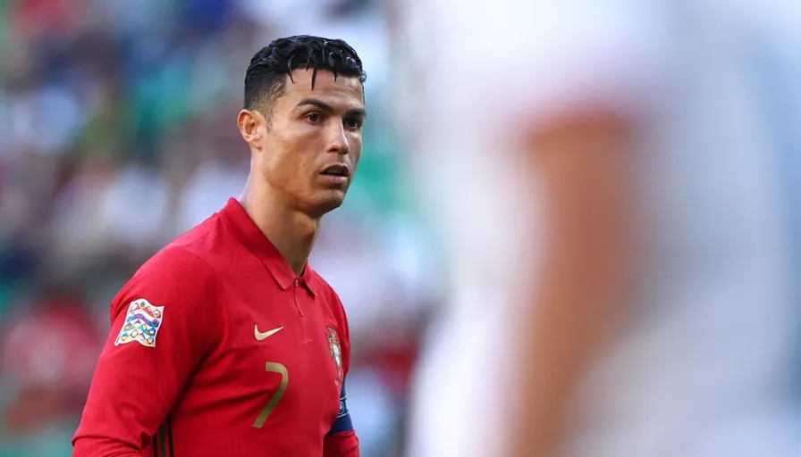 a close up of a soccer player wearing a red shirt