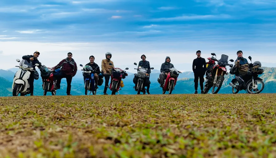 a group of people standing next to each other on top of a hill