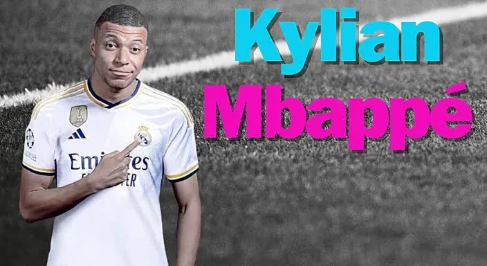 Mbappe standing in front of a soccer field