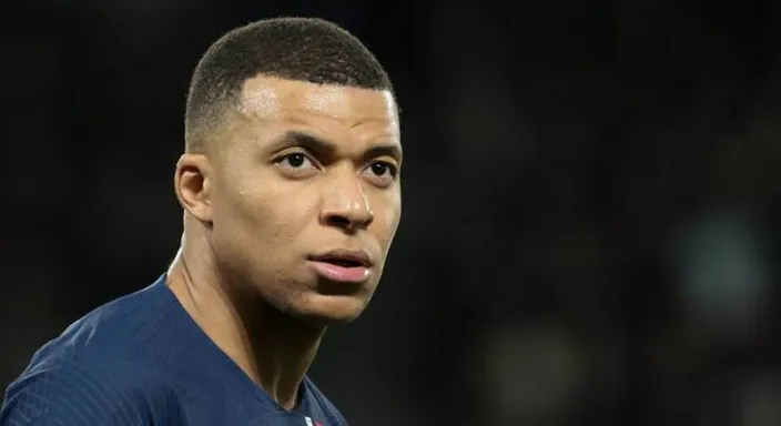 a close up of a mbappe with a serious look on his face