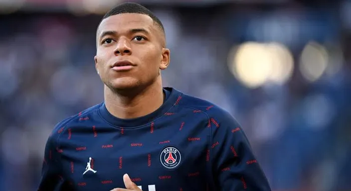 a close up of mbappe wearing a PSG jersey