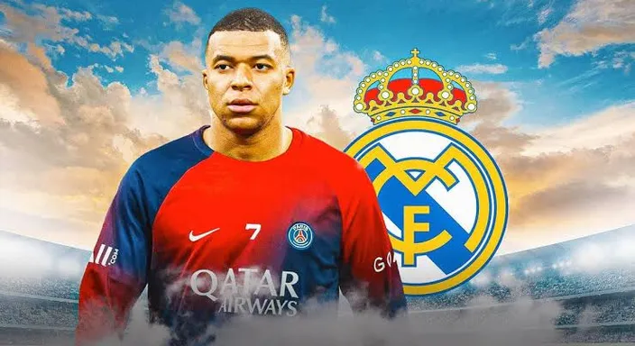 Mbappe standing in front of real madrid logo