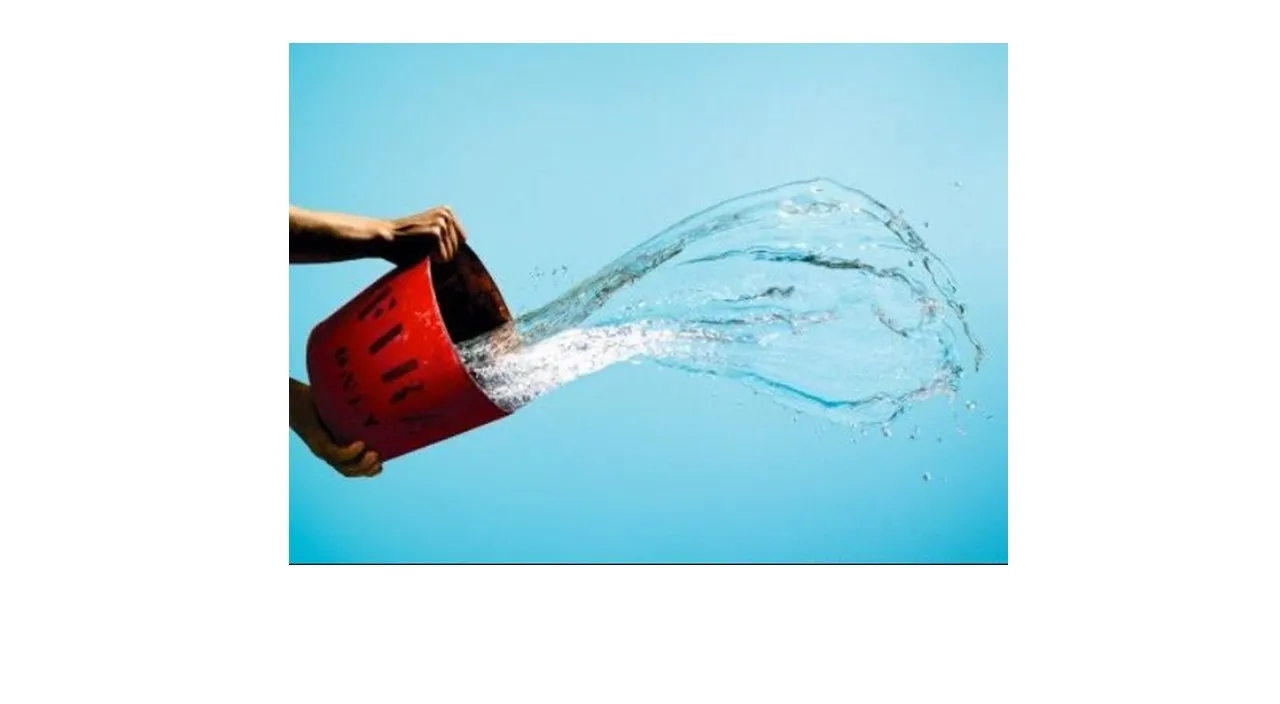 a person is holding a bucket with water coming out of it