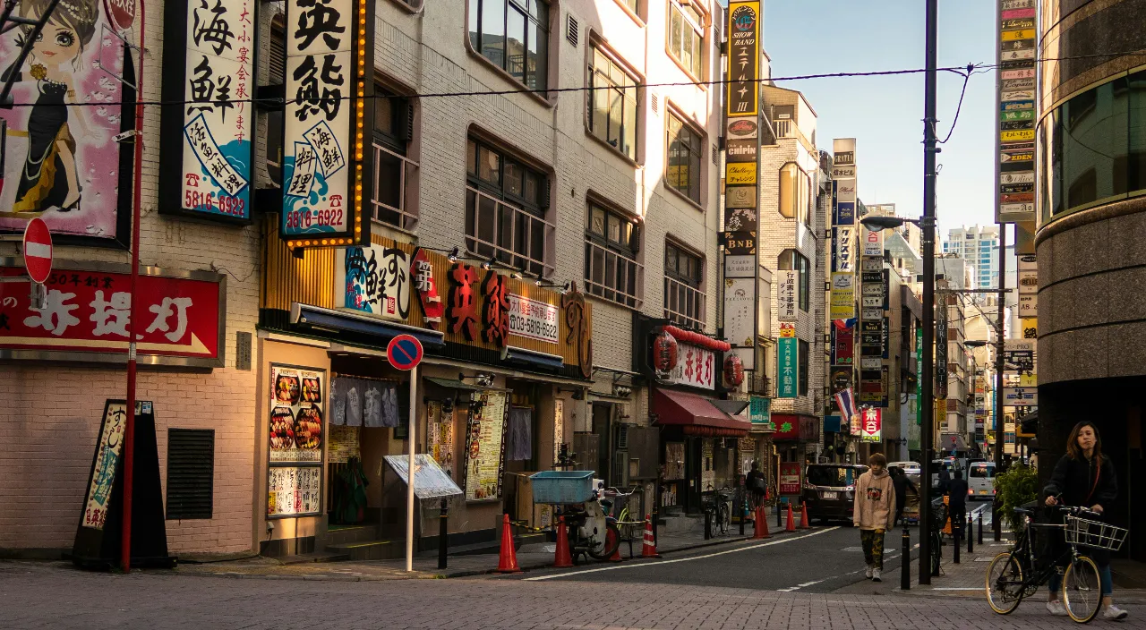 a city street filled with lots of tall buildings in Osaka Japan