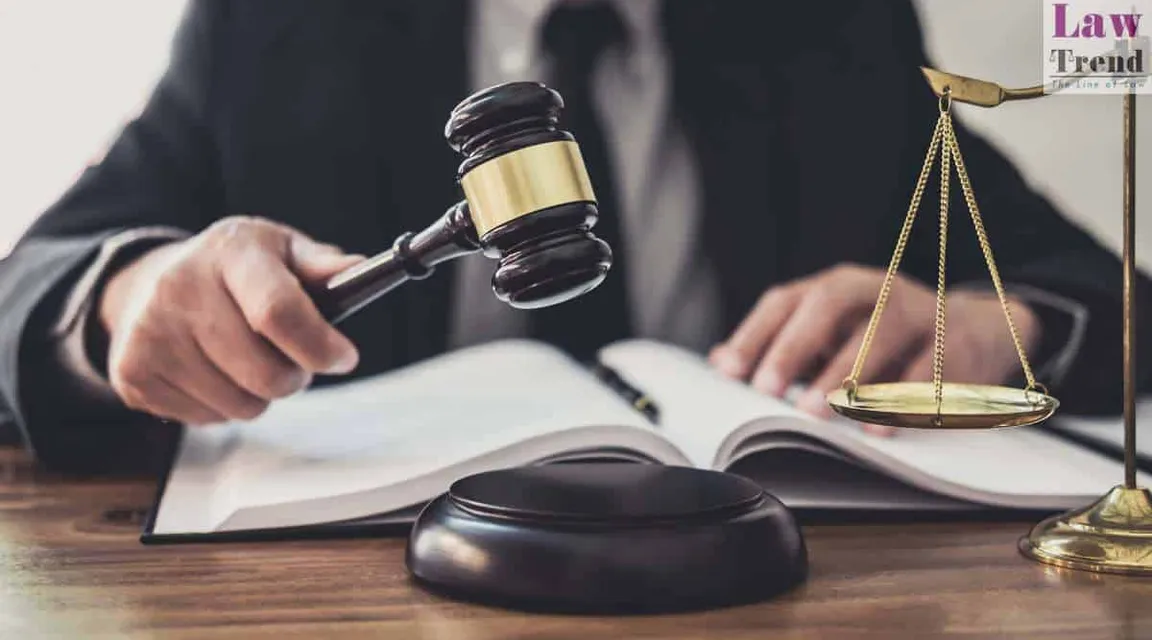 a judge holding a gaven and a book on a table