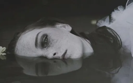 a woman is floating in a pool of water