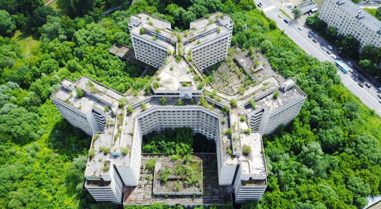 an aerial view of a building surrounded by trees