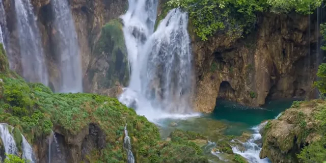 a waterfall in the middle of a forest