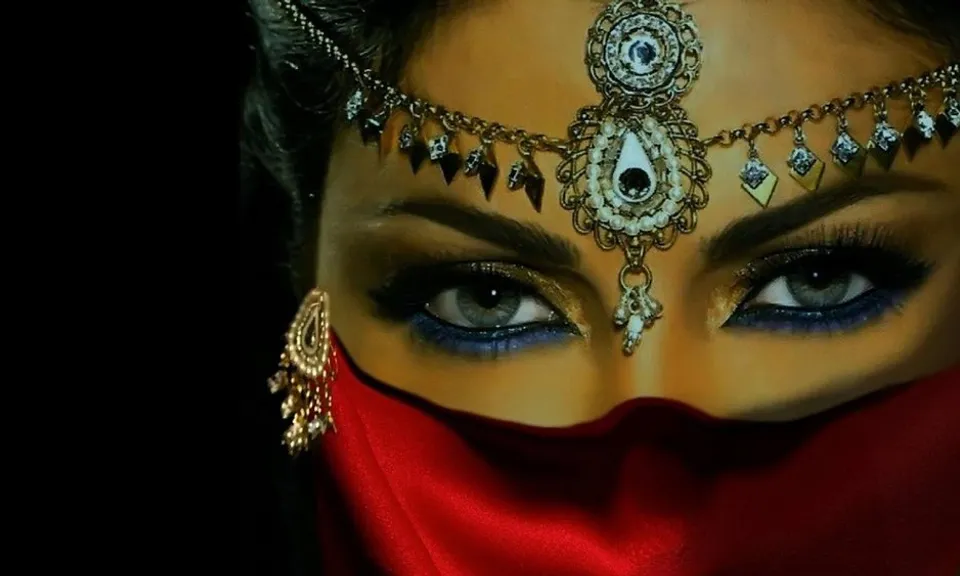 a close up of a woman wearing a red scarf