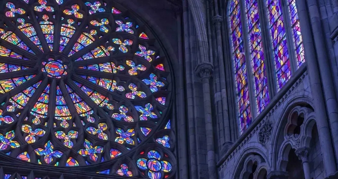 a large stained glass window inside of a cathedral