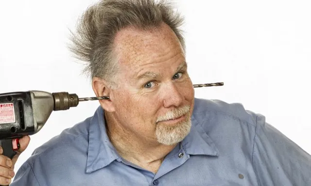 a man with a hair dryer on his head