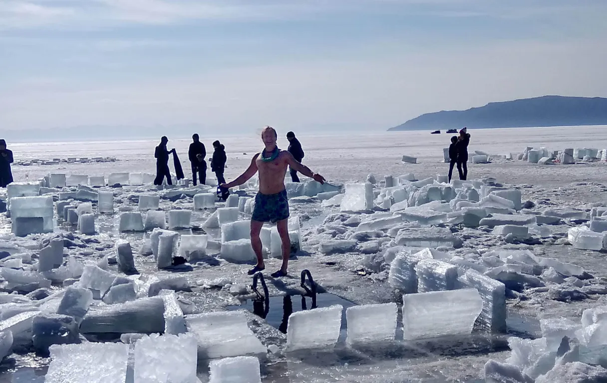 a man standing on top of a pile of ice blocks