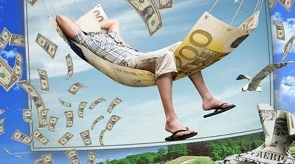 a man sitting in a hammock with money falling from the sky