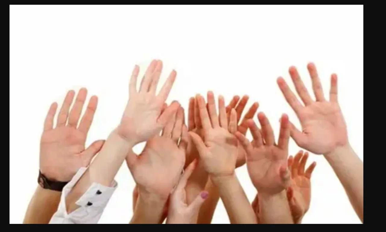 a group of people with their hands in the air