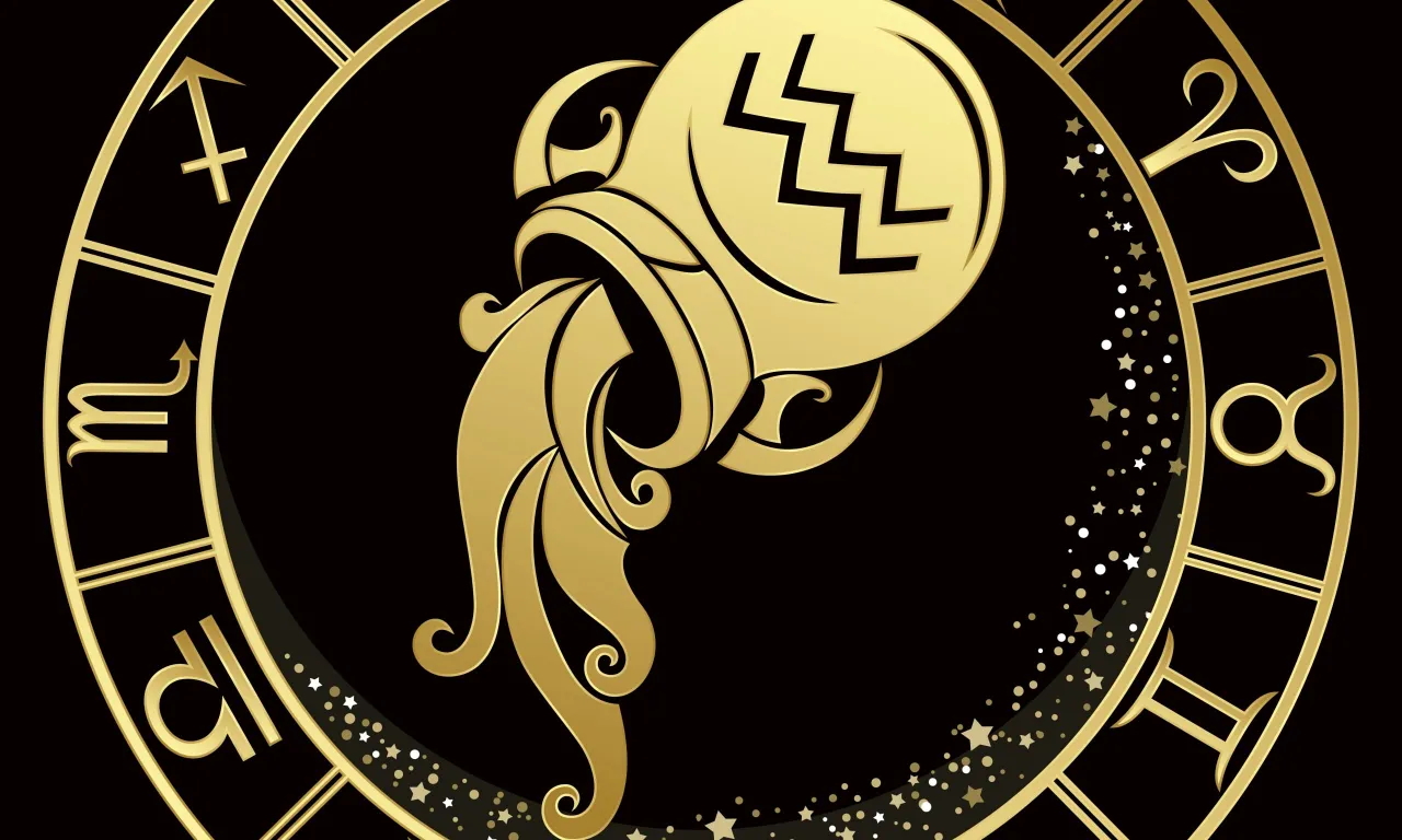 a gold zodiac sign on a black background