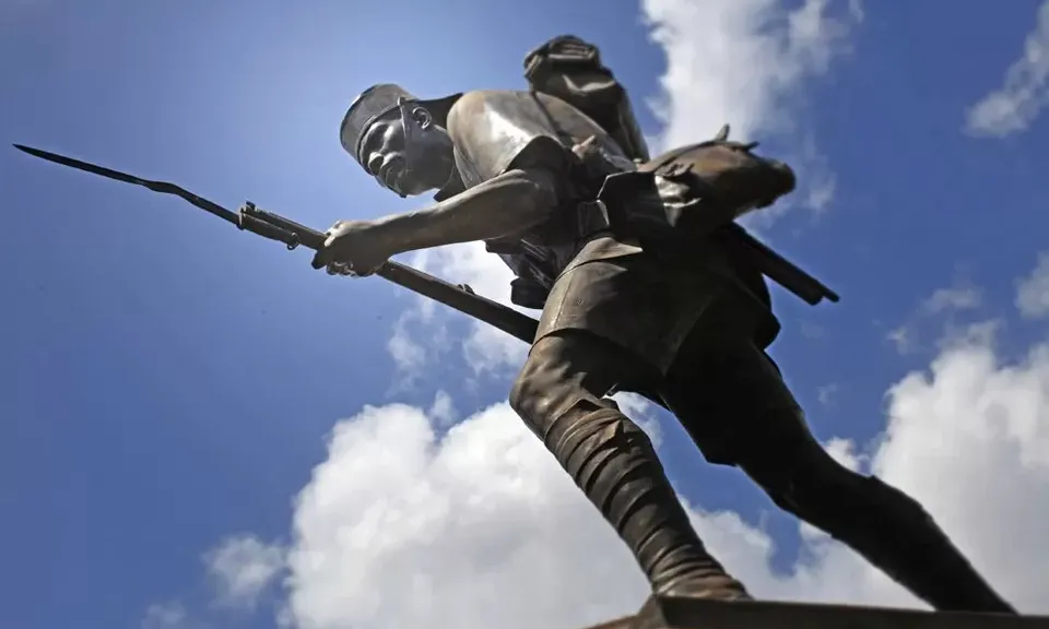 a statue of a man holding a rifle