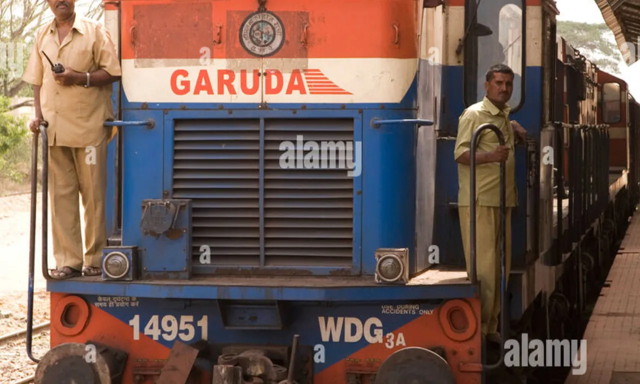 two men standing on the front of a train