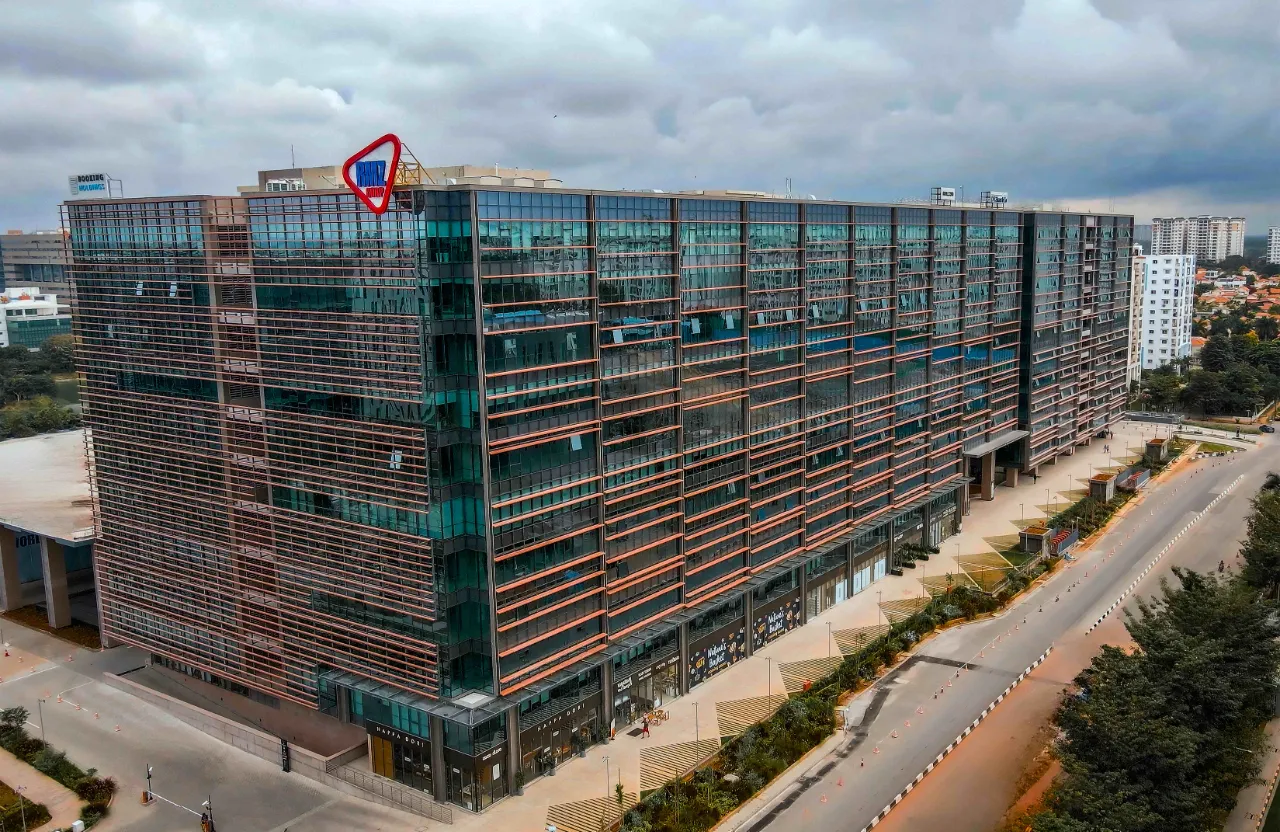 a large building with a red and blue sign on top of it