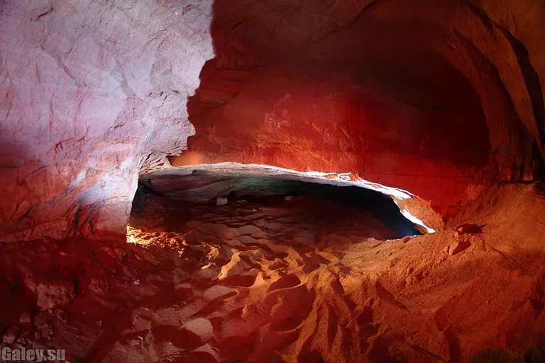 a cave filled with lots of red rocks