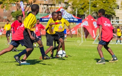 a group of young boys playing a game of soccer