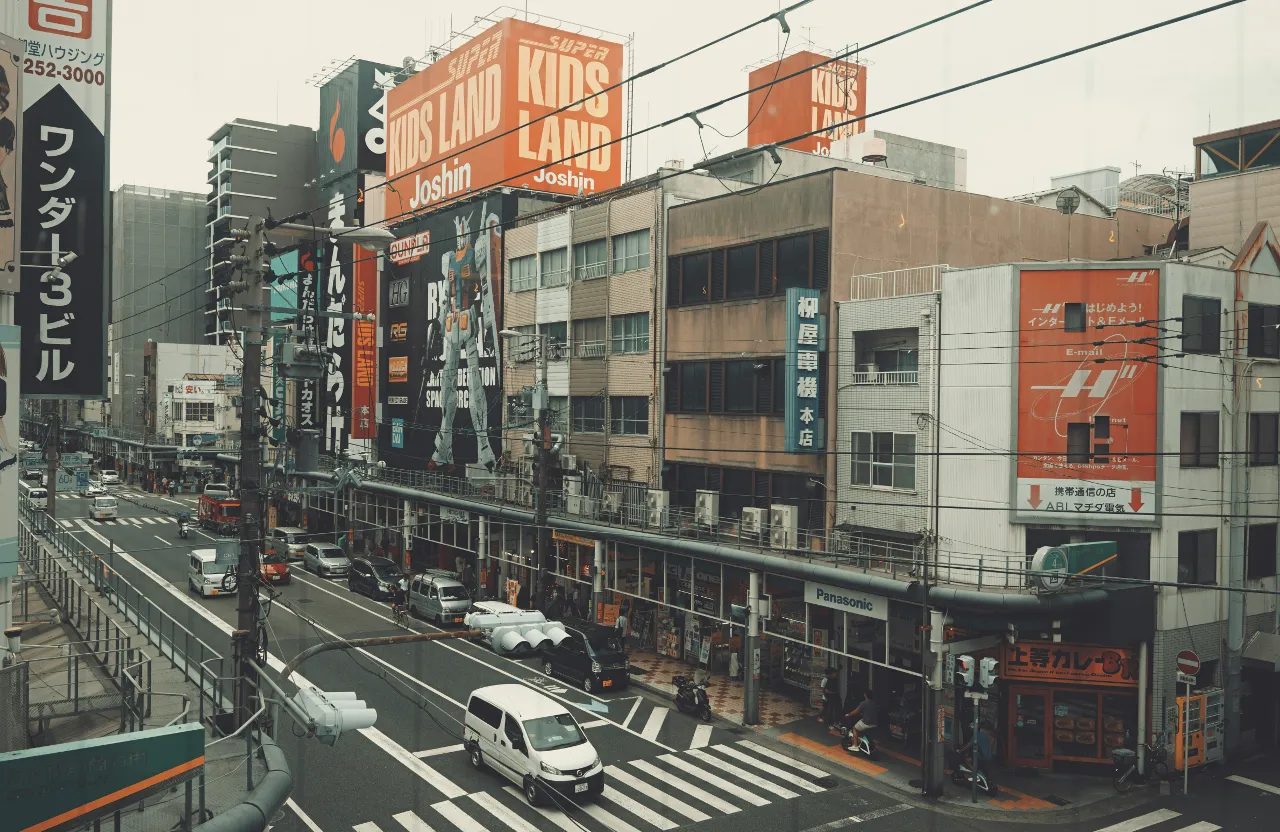 a city street filled with lots of tall buildings in Osaka Japan