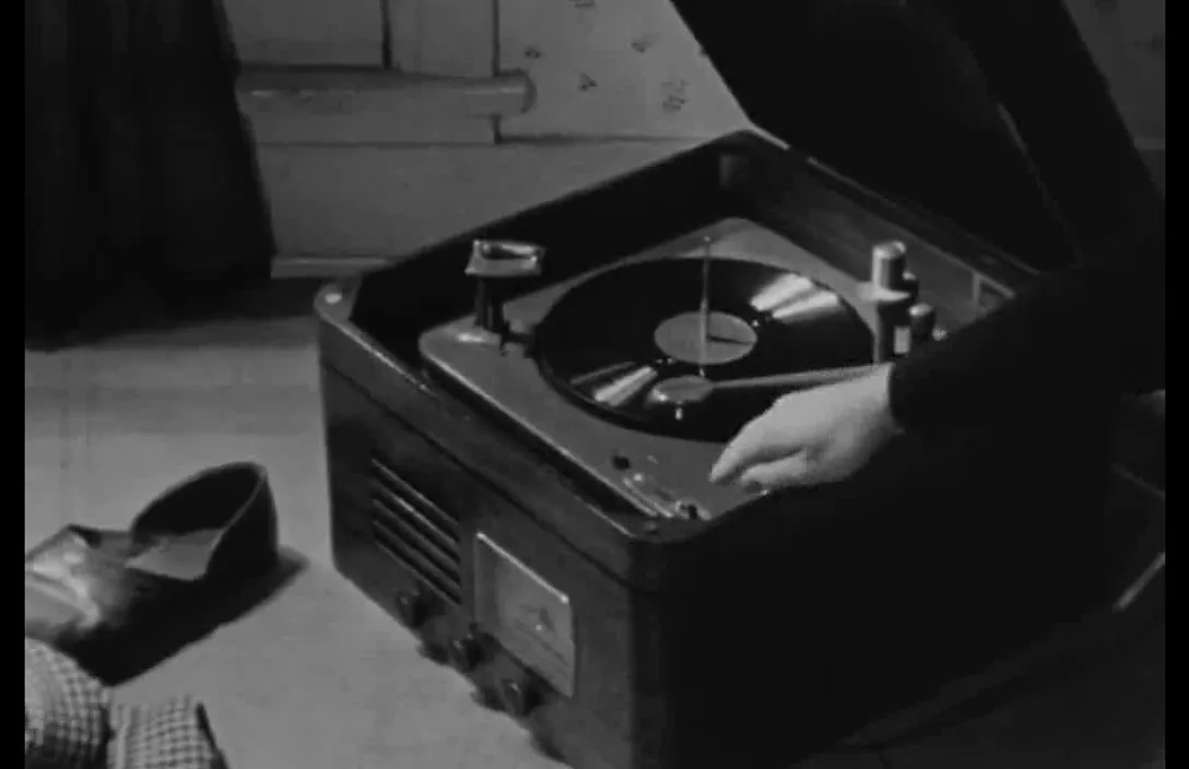 a record player in a suitcase with a pair of shoes