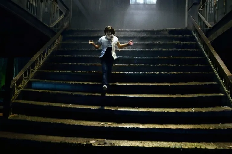 a woman is running down a flight of stairs