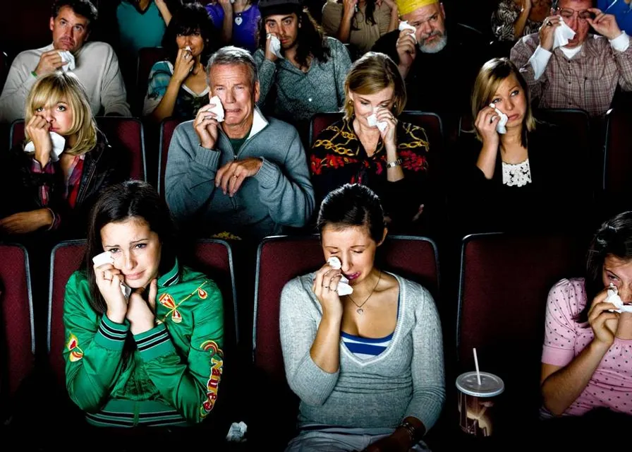 a group of people sitting in a movie theater