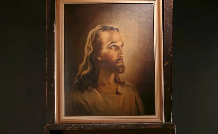 a painting of jesus in a wooden frame