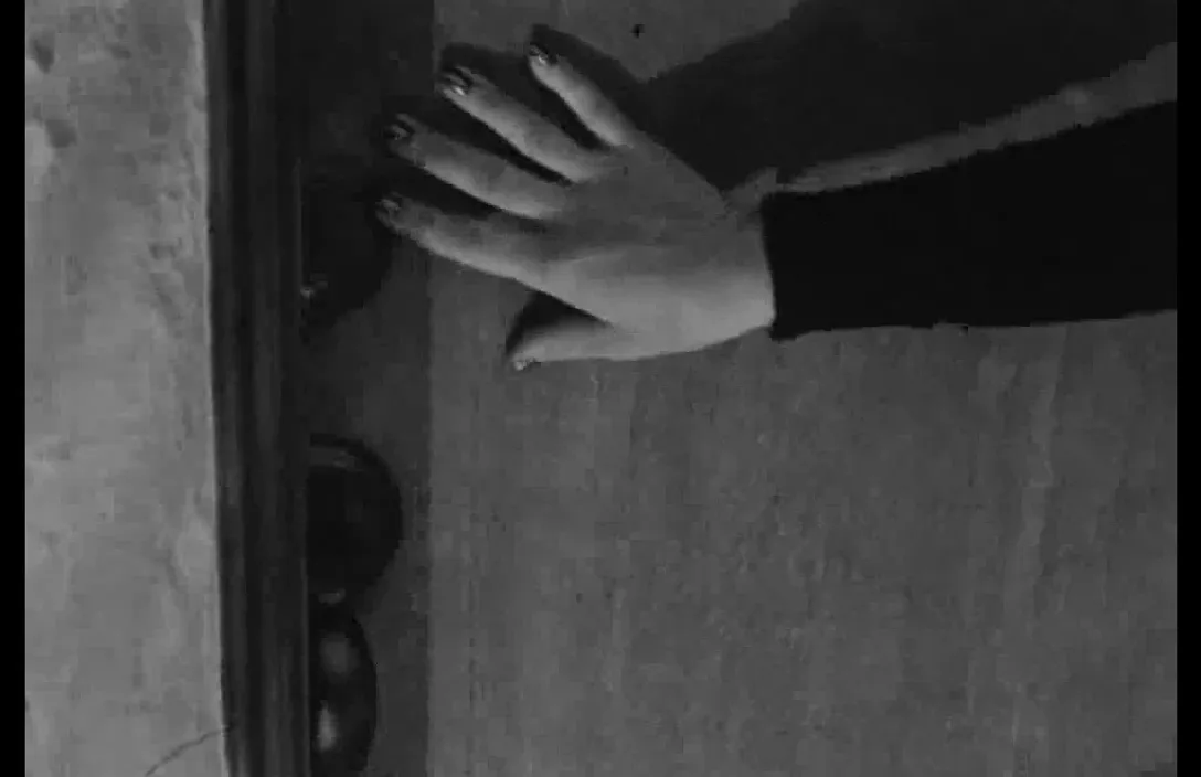 a woman's hand reaching for a door handle, realistic, cinematic