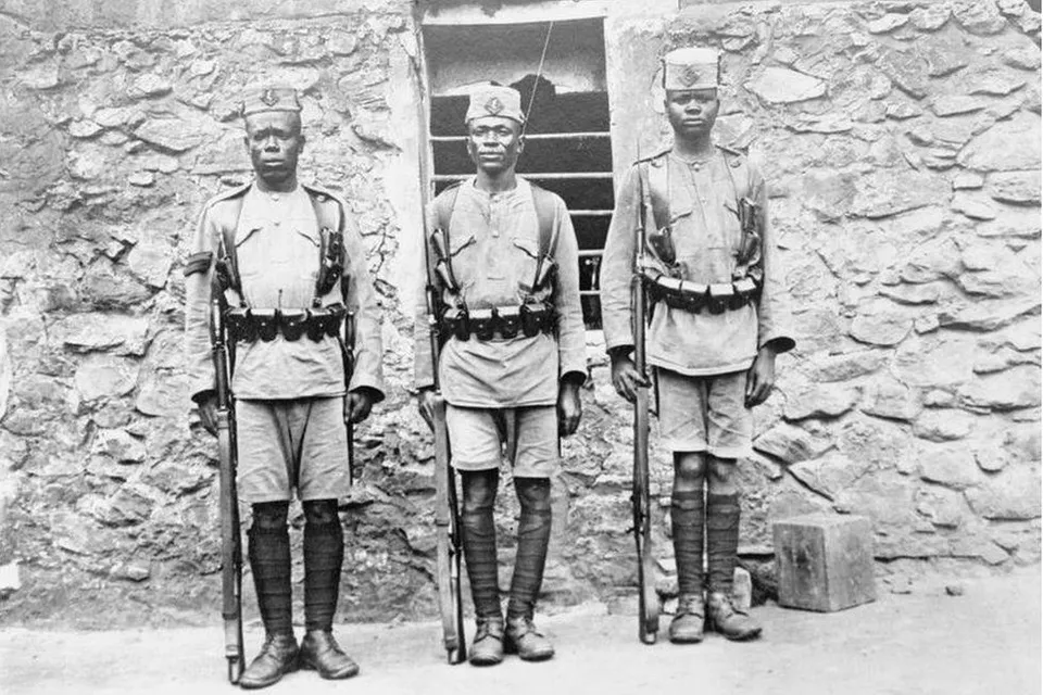 a group of african solders standing next to each other