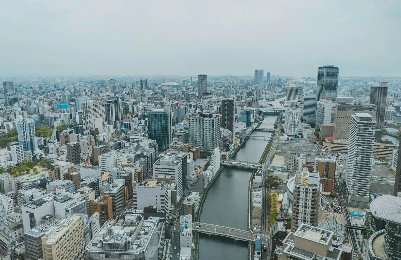 an aerial view of a city with tall buildings over Osaka Japan