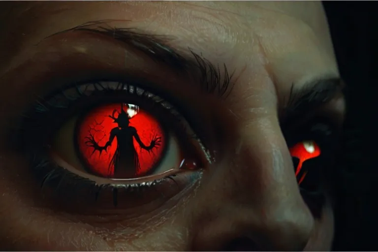 a close up of a person's eye with red eyes