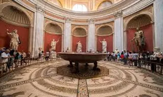 a group of people sitting in a large room with a bathtub in a center