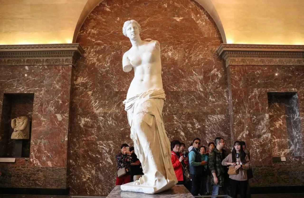 a group of people standing around a statue