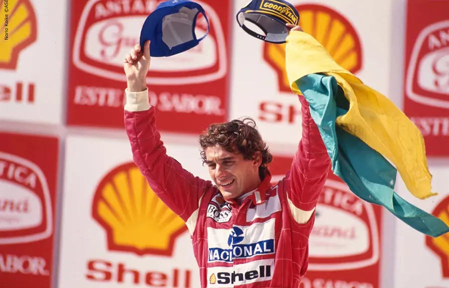 Ayrton Senna smiling and waving to the crowd