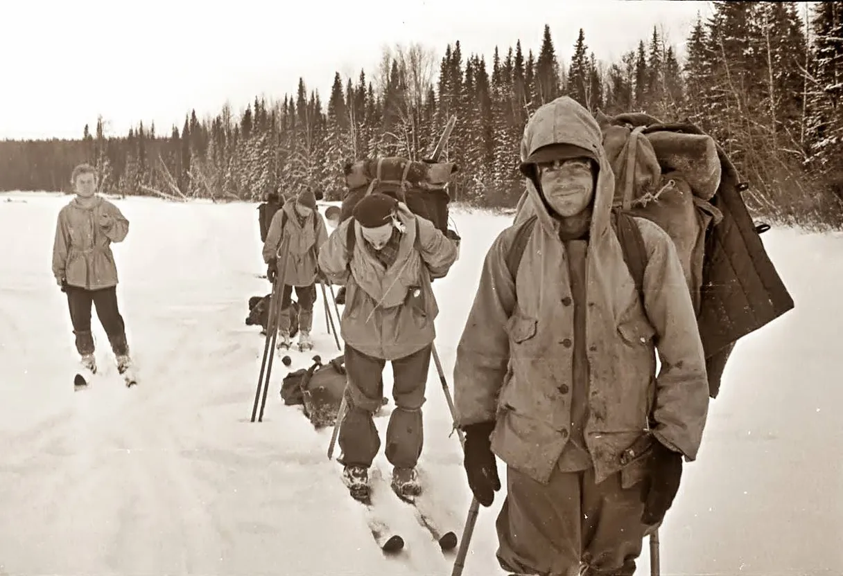 a group of people riding skis down a snow covered slope