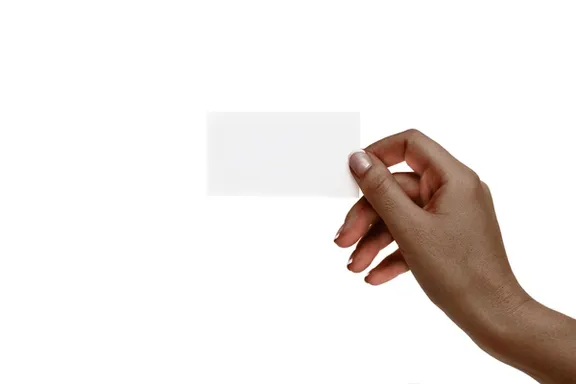 a hand holding a piece of white paper