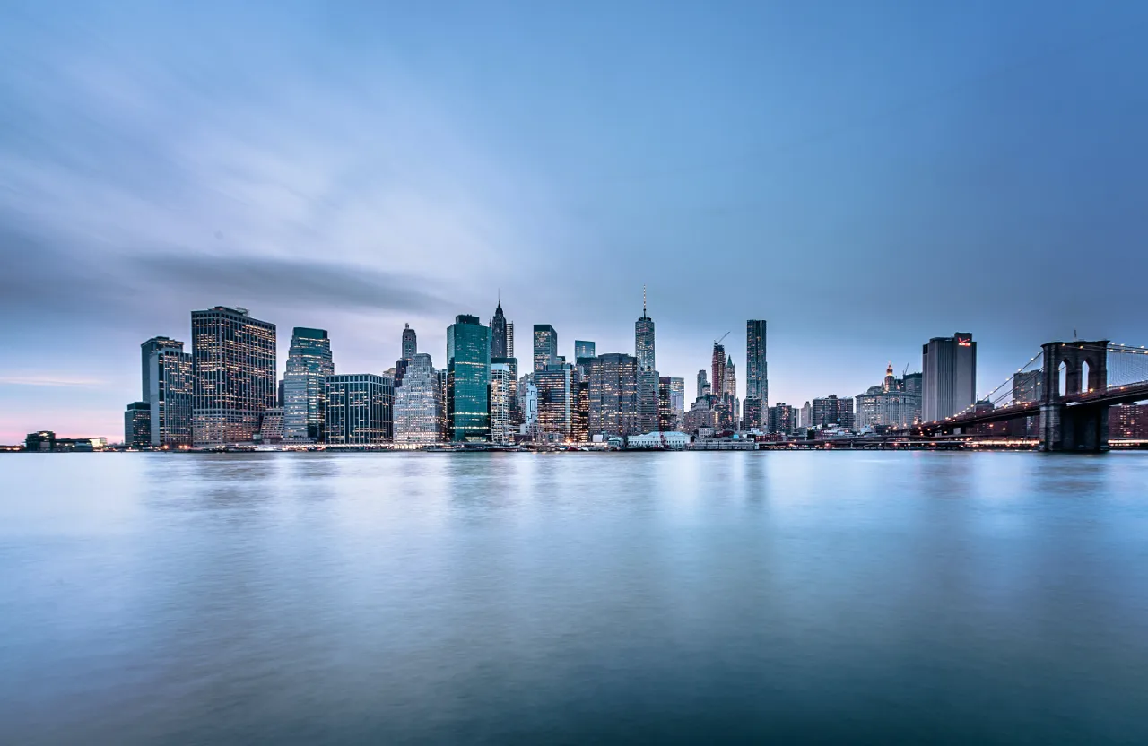 a city skyline with a bridge in the foreground