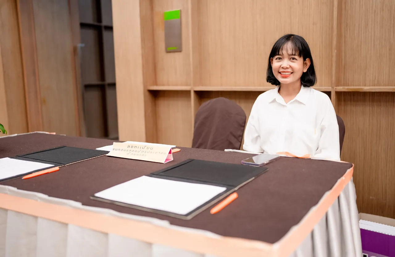 a woman sitting at a table with a book on it