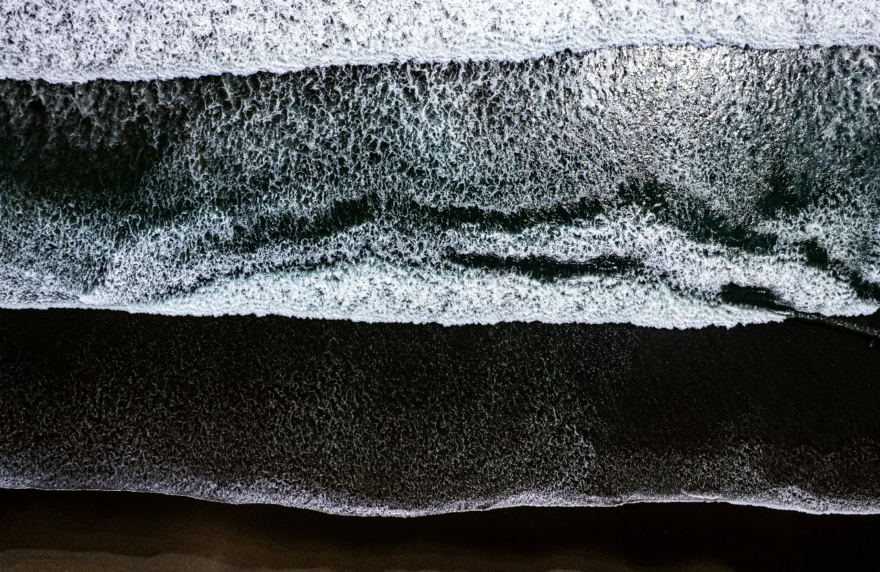 an aerial view of the ocean with waves