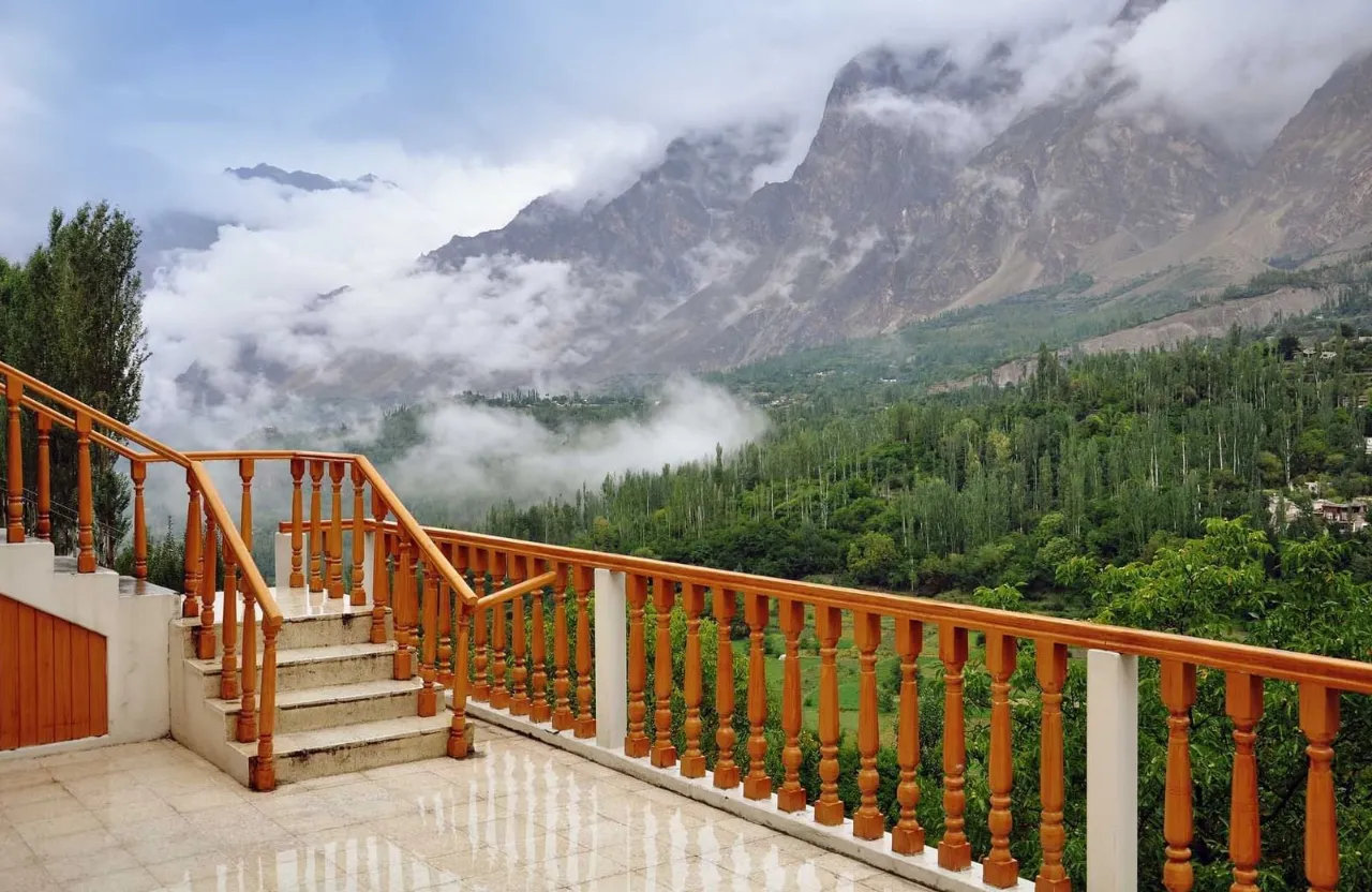 a balcony with a railing and a view of a mountain range